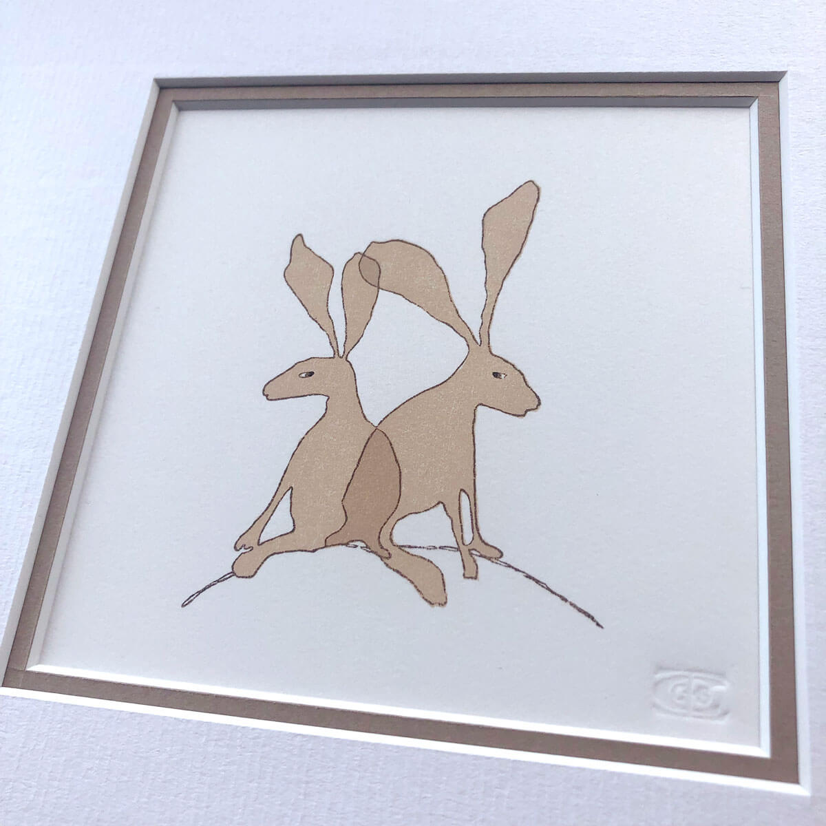 handmade woodblock print of brown hares